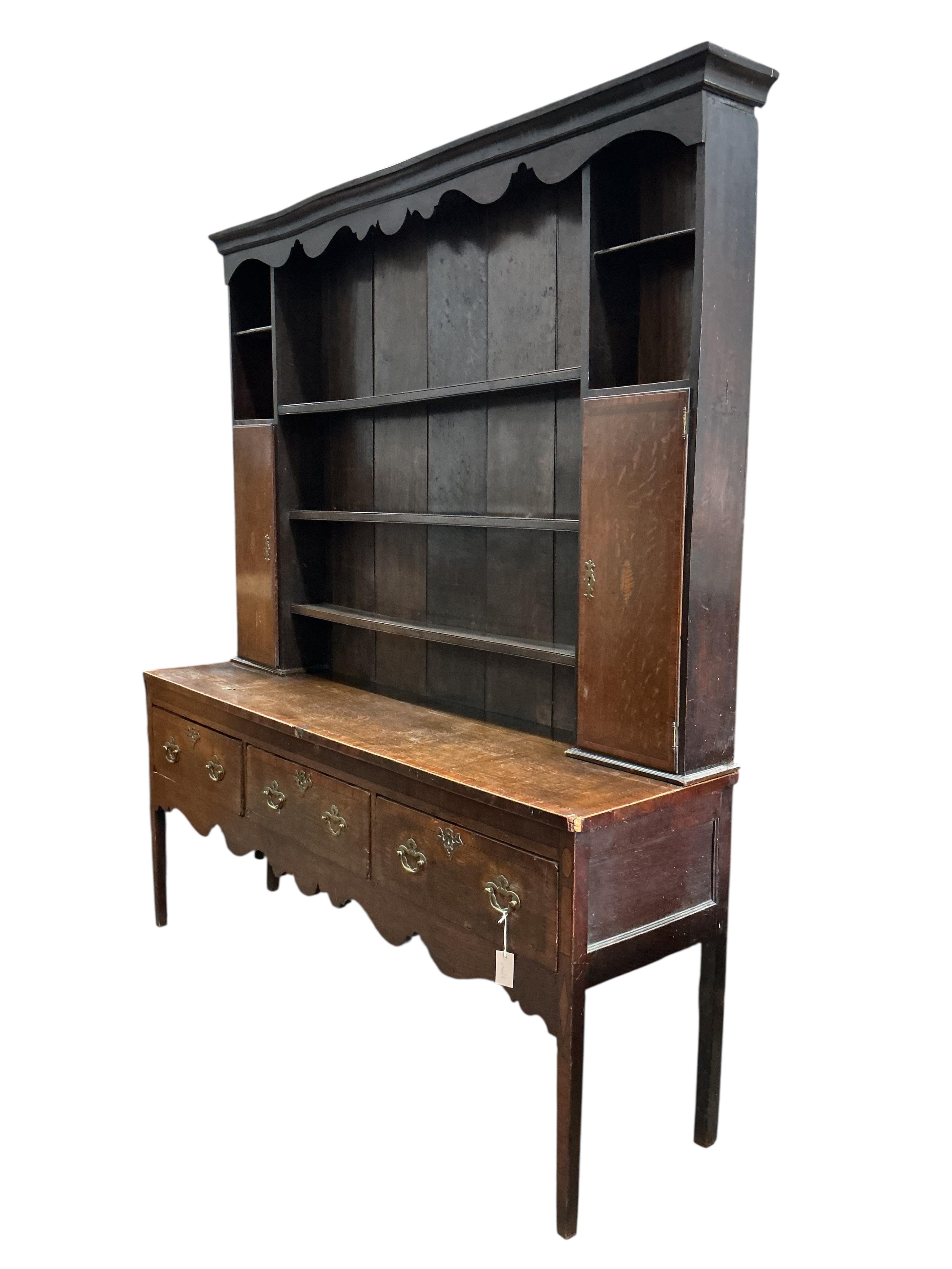 A George III banded mahogany dresser with boarded rack, width 185cm, depth 48cm, height 212cm